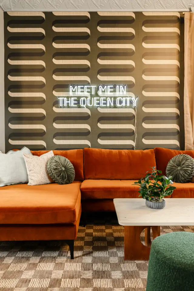 Stylish living room with comfortable seating and a playful nod to the Queen City