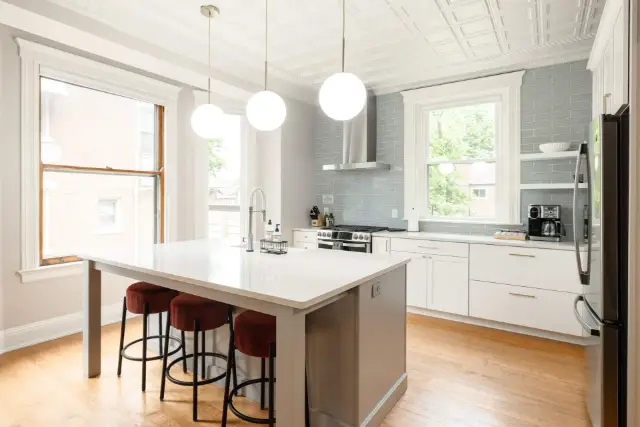 Open-concept kitchen, massive island with 3 barstools, amazing natural light