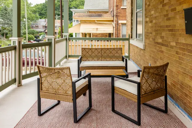 Welcoming front porch with comfortable seating—perfect for morning coffee, evening chats, and easing into your stay.