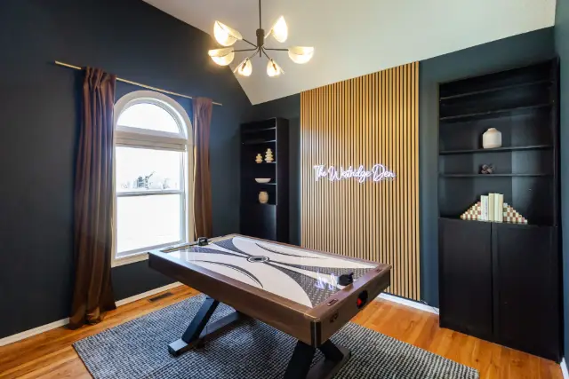 Enjoy a game of air hockey in the beautiful front room, adjacent to the entryway.