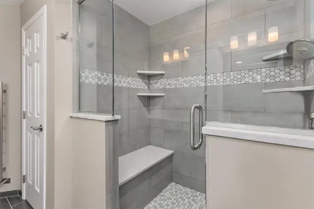 Ensuite shower is spacious and includes a built-in shower bench.